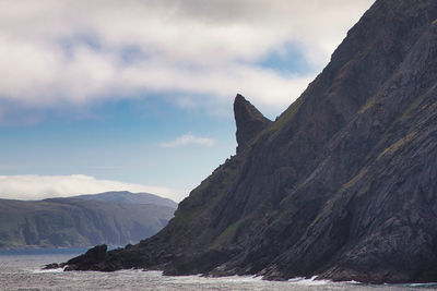 Scenic view of sea and mountains against sky