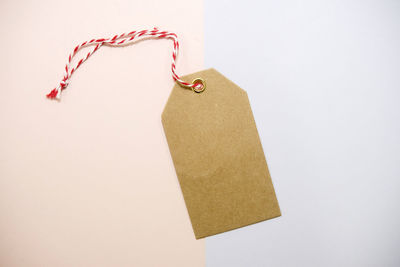 High angle view of paper hanging on table against white background