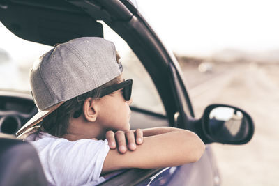 Portrait of man wearing sunglasses while sitting in car