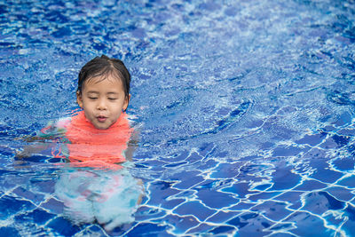 Little adorable girl have fun at outdoor swimming pool