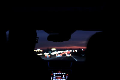 Silhouette of car on road at night