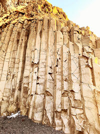 Low angle view of rock formation on land against sky