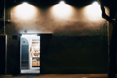 Illuminated lights on wall of building