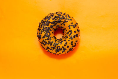 Close-up of orange slice against yellow background