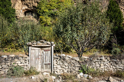 View of stone wall with trees in foreground