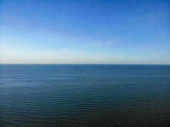 Scenic view of sea against blue sky