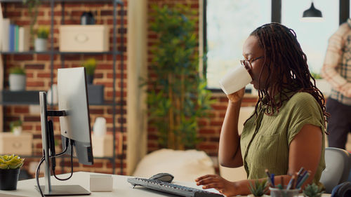 Businesswoman using mobile phone while sitting in cafe