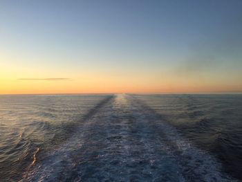 Scenic view of sea against clear sky during sunset