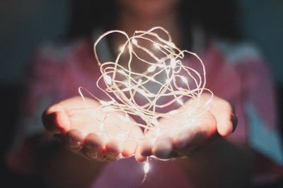 Close-up of hand holding illuminated light