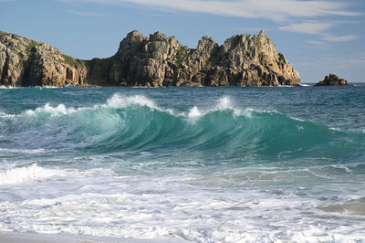 Scenic view of rocks in sea against sky