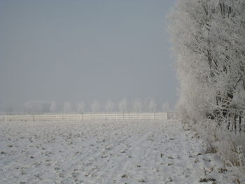 Scenic view of snow covered landscape against clear sky