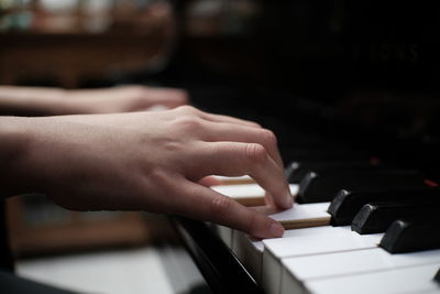 Midsection of woman playing piano