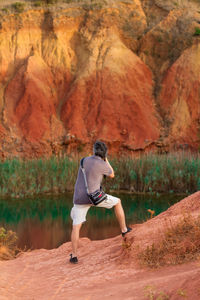 Rear view of woman standing on shore