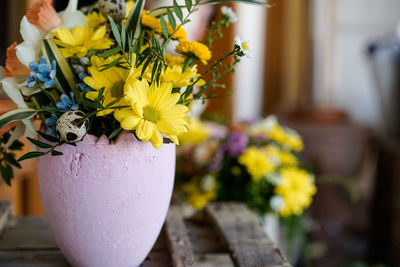 Close-up of yellow flower pot on table