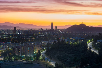 High angle view of illuminated buildings against sky during sunset