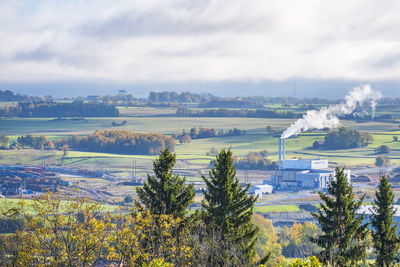 Smoking chimney on a heating plant in an industrial area