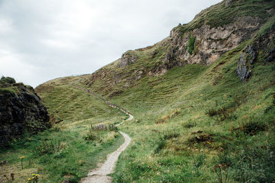 Dirt road along countryside landscape