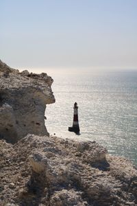 Woman looking at sea against clear sky