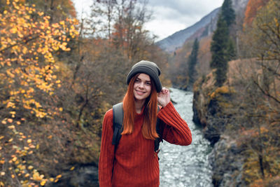 Young woman standing in park during autumn