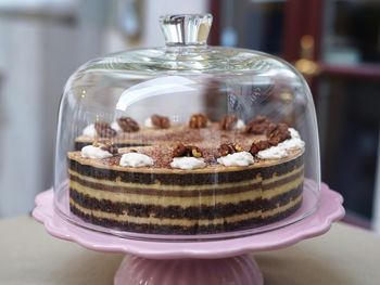 Close-up of cake under a cake dome