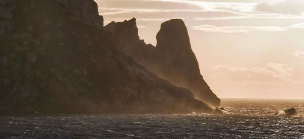 Scenic view of sea and rock formation against sky