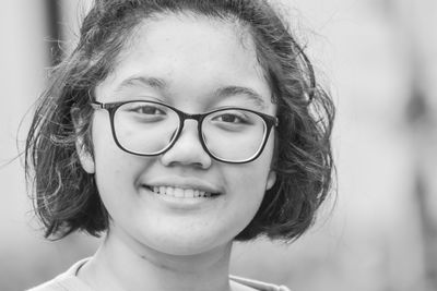 Close-up portrait of smiling young woman