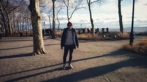 Full length of man standing by tree in city