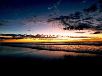 Scenic view of lake against sky at sunset