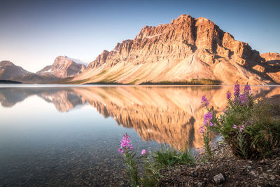 Scenic view of lake and mountains against sky