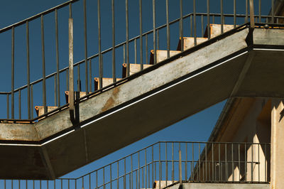 Low angle view of staircase against building in sepulveda, spain, against blue sky