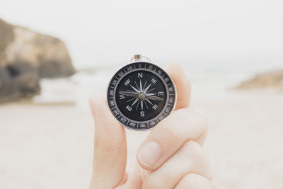 Close-up of hand holding navigational compass