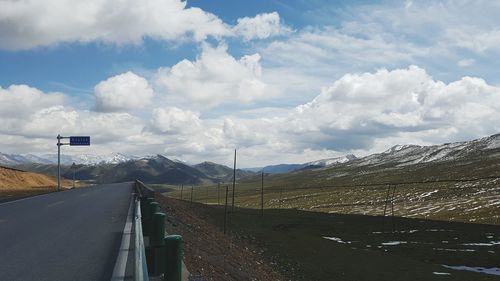 Empty road along countryside landscape