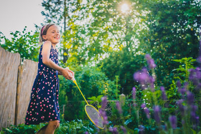 Woman standing by plants