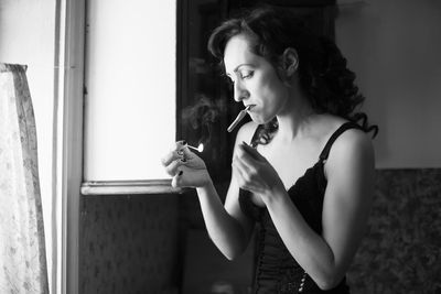 Woman lighting cigarette