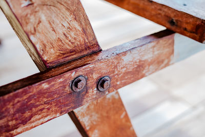 Close up wooden table rivets on the picnic stool furniture.