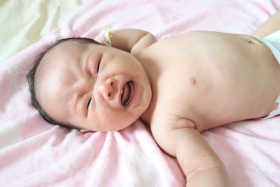 Cute baby lying on bed