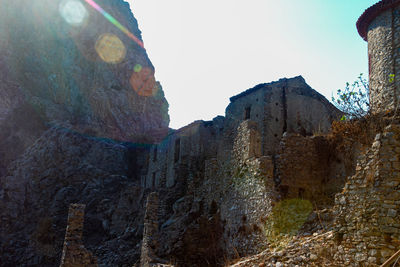 Low angle view of rock formations against sky