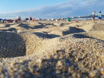 Close-up of sand on beach against sky