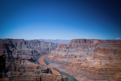 Scenic view of mountains against clear blue sky