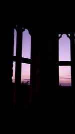 Silhouette built structure against sky at sunset