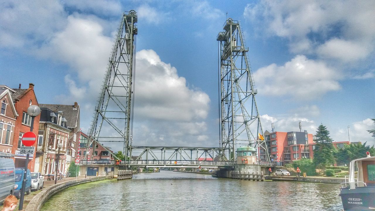 architecture, built structure, sky, cloud - sky, water, cloudy, cloud, city, day, outdoors, no people, canal, weather, development, nature, overcast, residential district, rippled