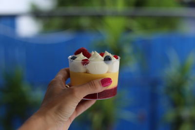 Close-up of hand holding ice cream