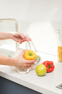 Midsection of person washing hands in sink