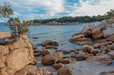 Rocks on beach against sky