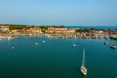 Boats in sea against clear sky