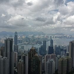 Cityscape against cloudy sky