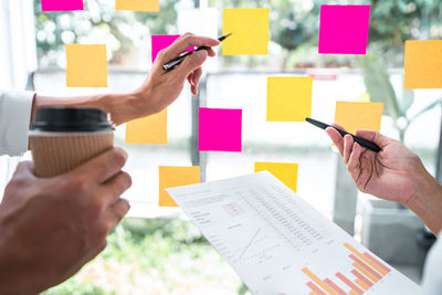 Cropped image of business colleagues working at office