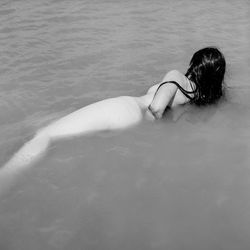 Woman lying down in swimming pool