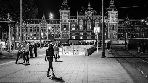 People walking in city at night