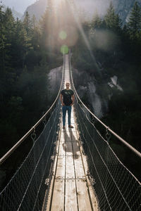 Rear view of man on footbridge